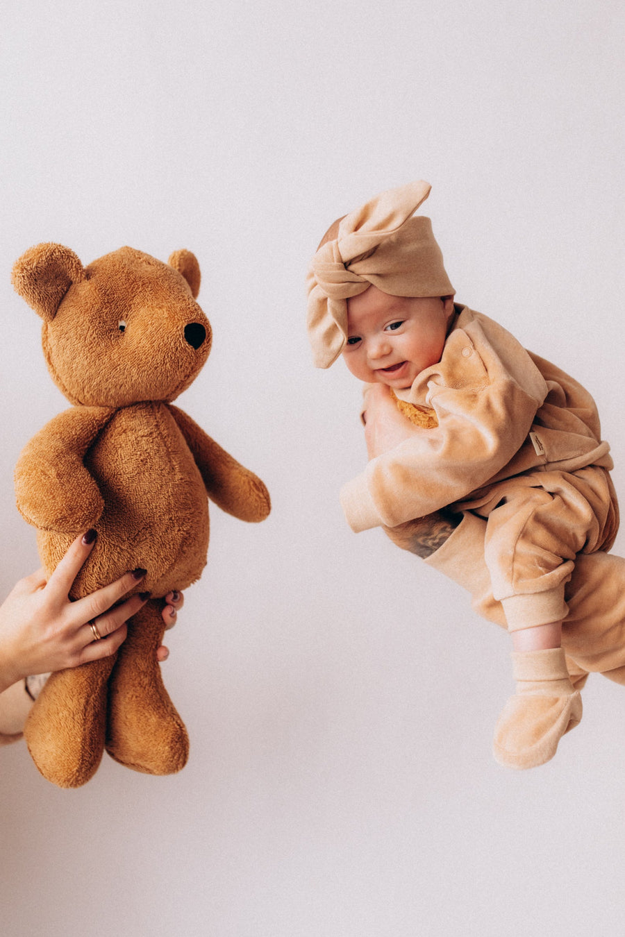 Merino and silk baby clothing with a soft toy